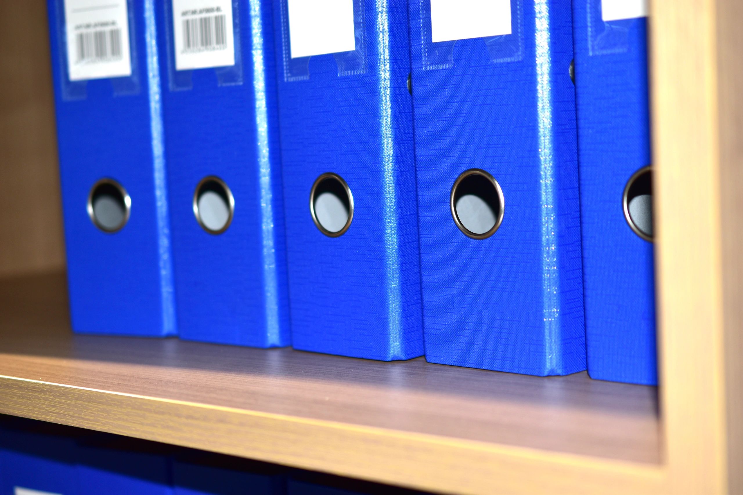 Professional office desk with organized blue document folders
