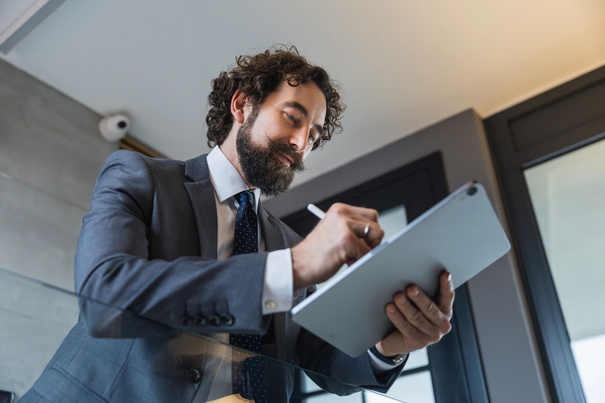 Professional signing a digital document on a tablet